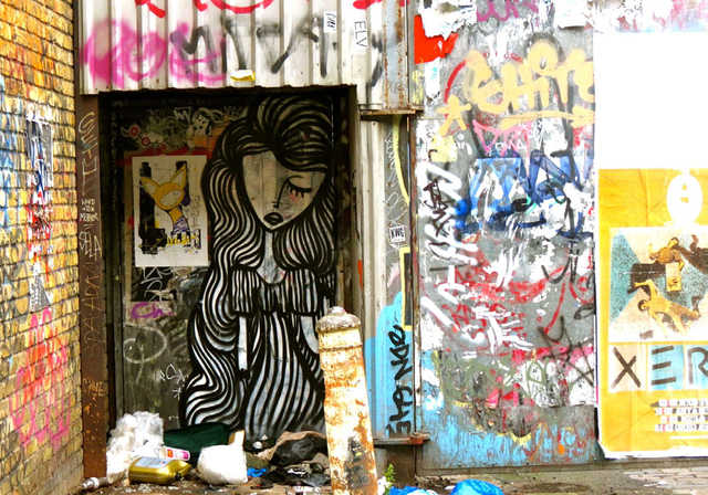 THIS PAINTING OF A WOMAN JUXTAPOSED WITH GARBAGE AND GRAFFITI SCRAWLS WAS INSPIRATION FOR THE TITLE OF THIS PAPER