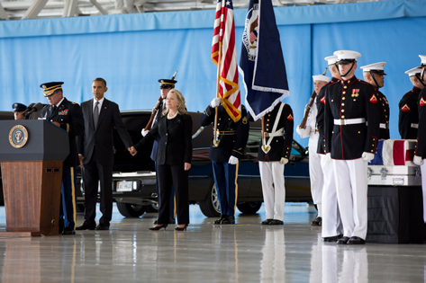 President Obama and Secretary of State Hilary Clinton stand during the transfer of remains ceremony, celebrating the sacrifice of Christopher Stevens, Sean Smith, Glen Doherty and Tyrone Woods, who were killed in the attack