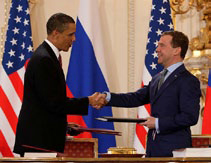 Barack Obama and Dmitri Medvedev shake hands after signing the New START Treaty.