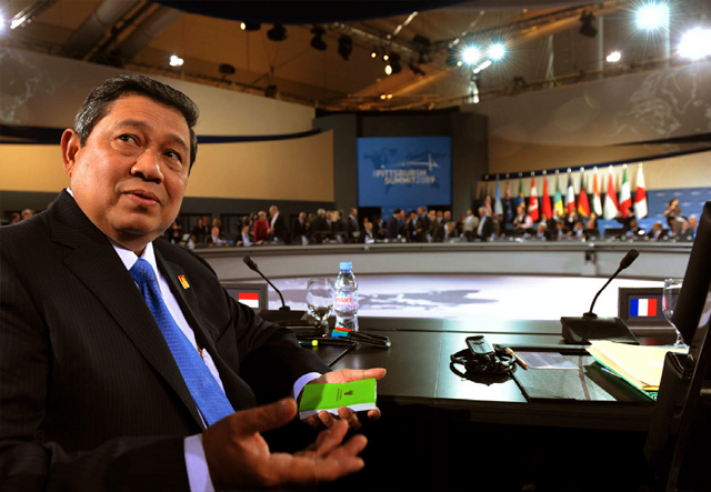 Susilo Bambang Yudhoyono, the President of Indonesia, takes his seat at the conference table.
