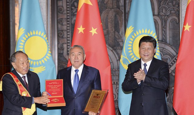 President Nazarbayev and President Xi Jinping, pictured center and right, at a talk before Xi Jinping accepted a peace prize for his New Silk Road vision.